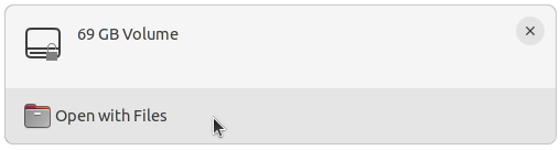 A desktop notification showing a new "69GB volume" has been mounted, with an action button at the bottom labelled "Open with Files"