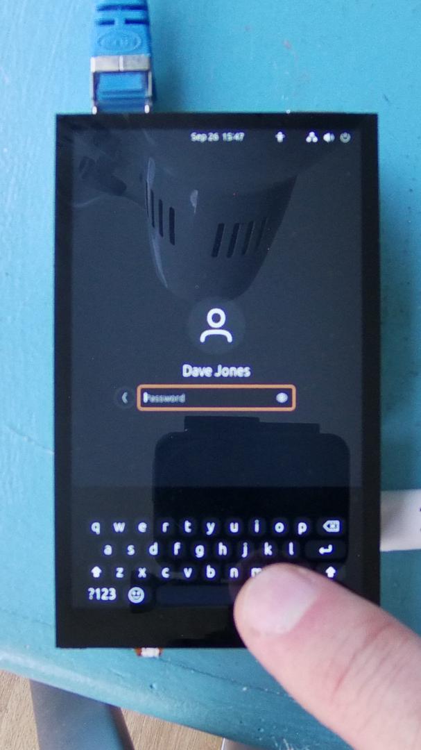 Dave's fat finger poised over the teeny-tiny on-screen keyboard about to try and enter his login password (before giving up and re-attaching the conspicuously absent USB keyboard)